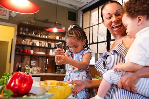 Free A Little Girl Preparing Food with her Mother Stock Photo