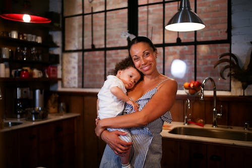 Free A Happy Woman Carrying her Son Stock Photo