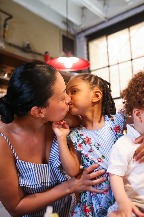 A Woman Kissing her Young Daughter