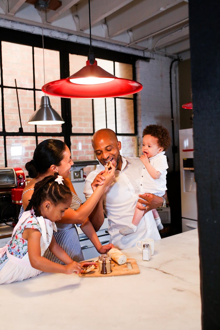 A Family Eating In The Kitchen