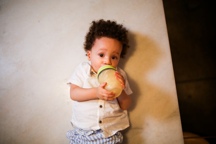 Boy Drinking On His Baby Bottle 