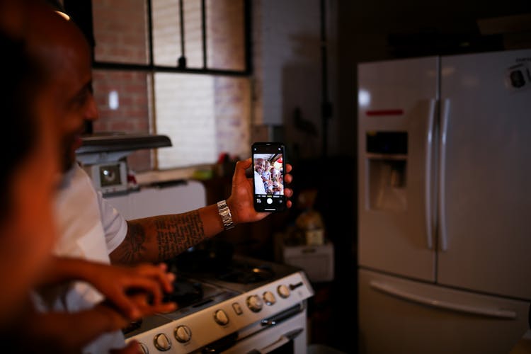 Father And Child Taking Picture Using A Smartphone