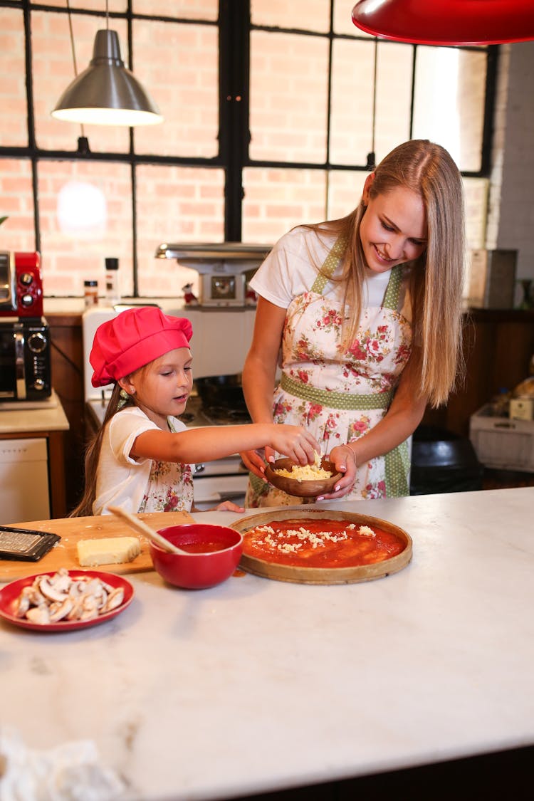 Mother And Daughter Cooking In The Kitchen