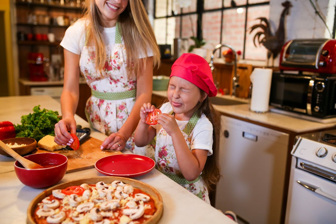 Free Woman in White and Red Floral Dress Eating Stock Photo