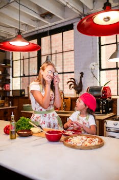 A joyful scene of mother and daughter preparing pizza in a cozy kitchen.