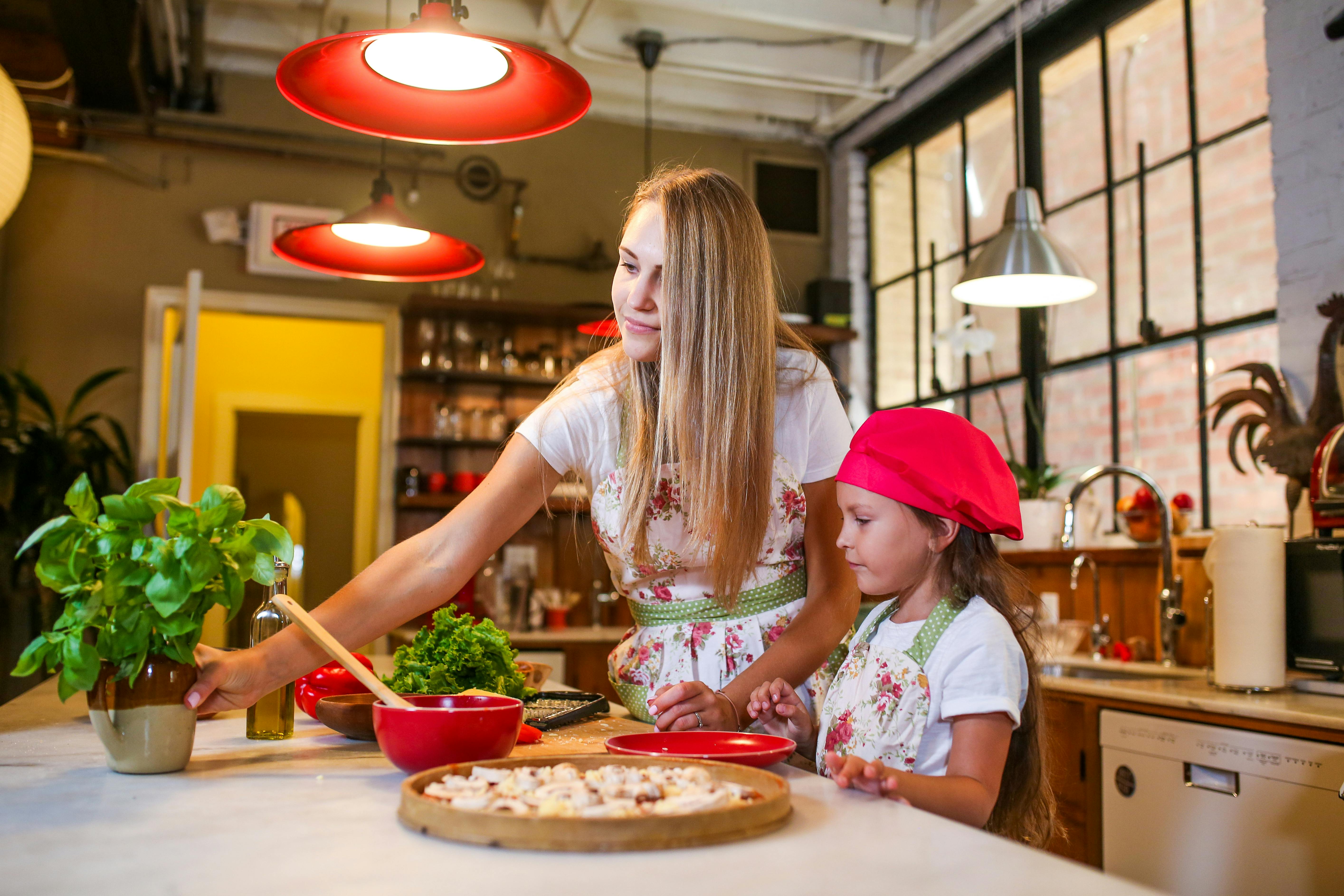 woman in red hat sitting on chair in front of table with food