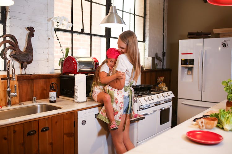 A Happy Mother And Daughter Bonding Time In The Kitchen