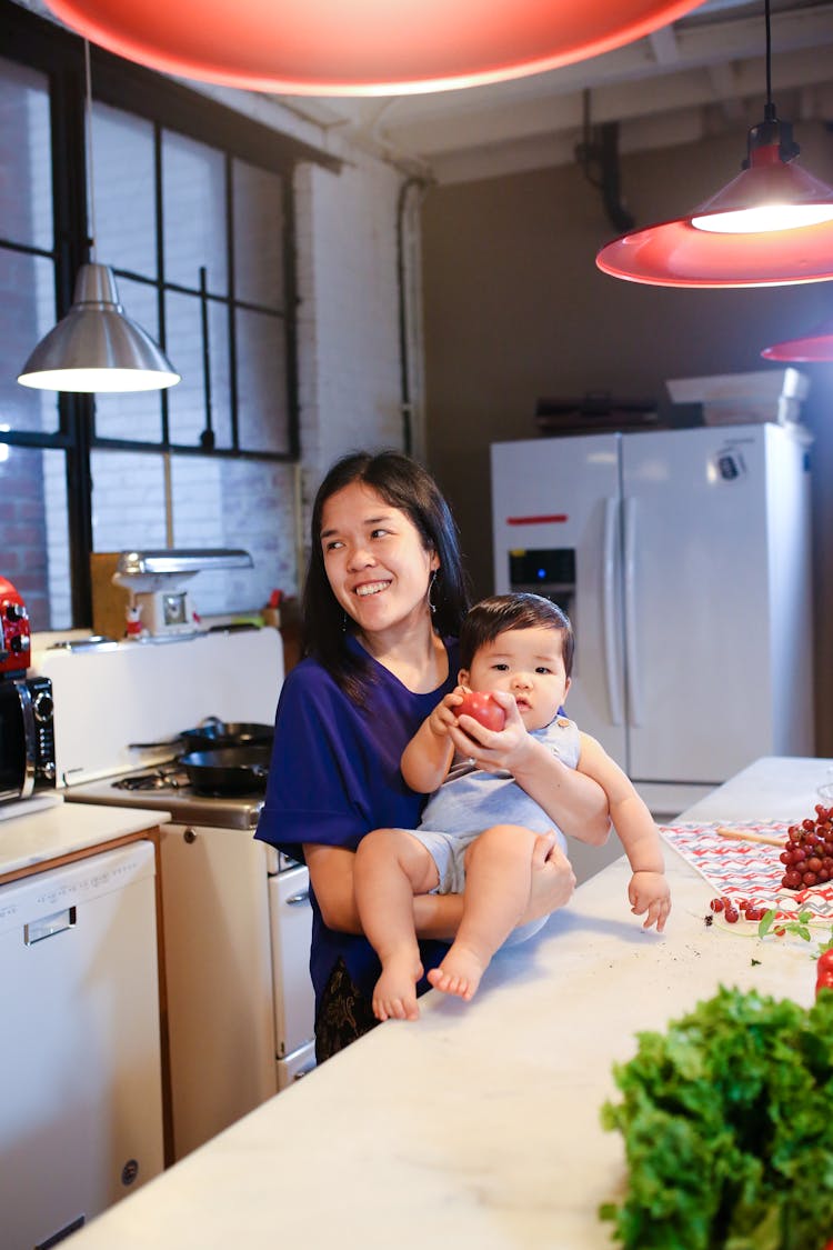 Woman In Blue T-shirt Carrying Baby In Blue Onesie