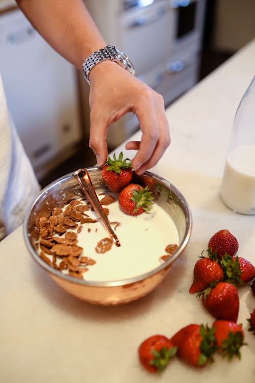 Person Holding Stainless Steel Bowl With Strawberries