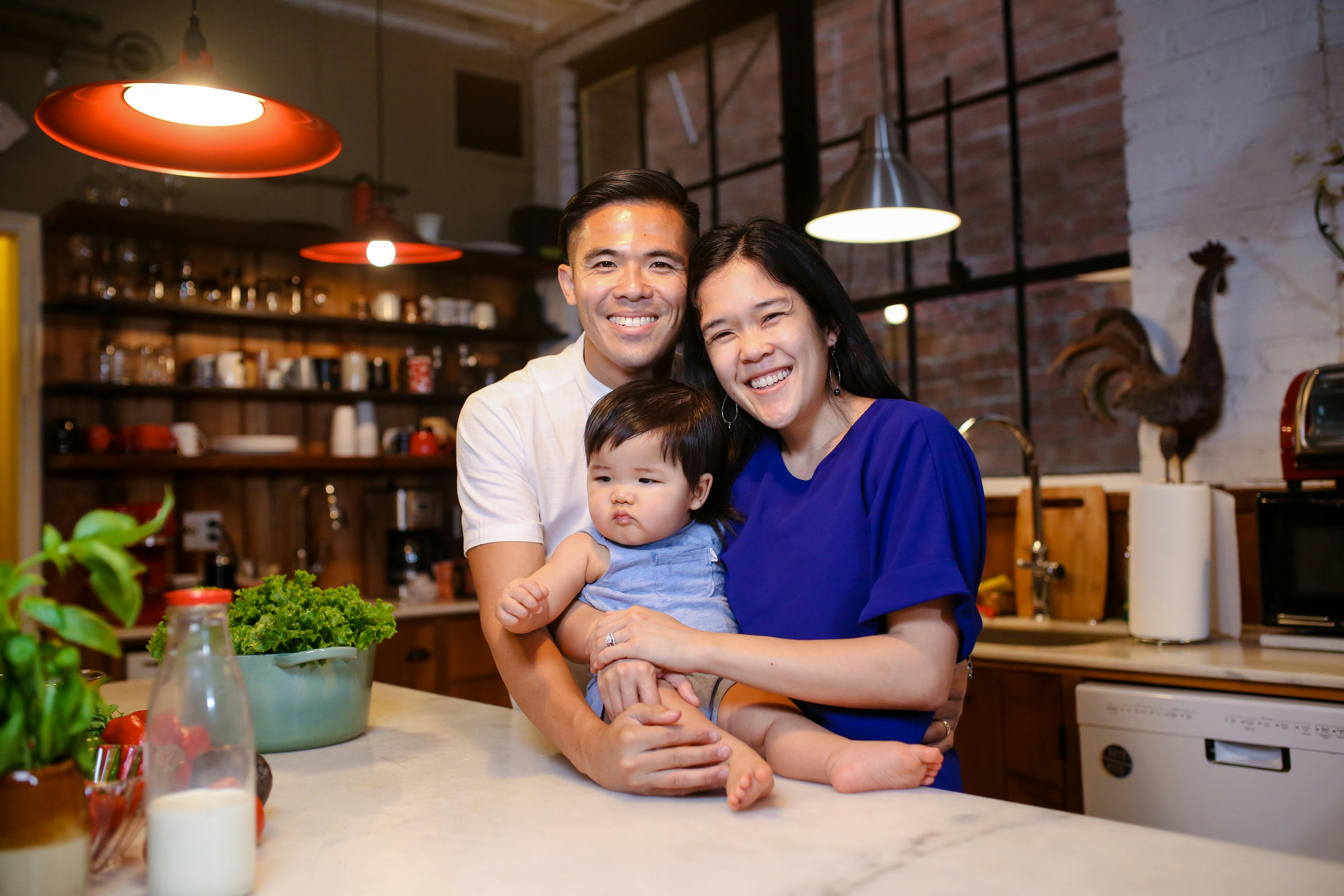 woman in blue shirt smiling beside girl in white shirt