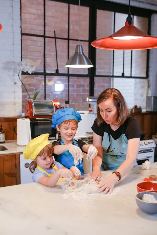 A Mom Baking with her Kids in a Kitchen