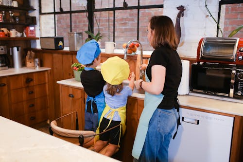 Children Washing their Hands in a Kitchen Sink