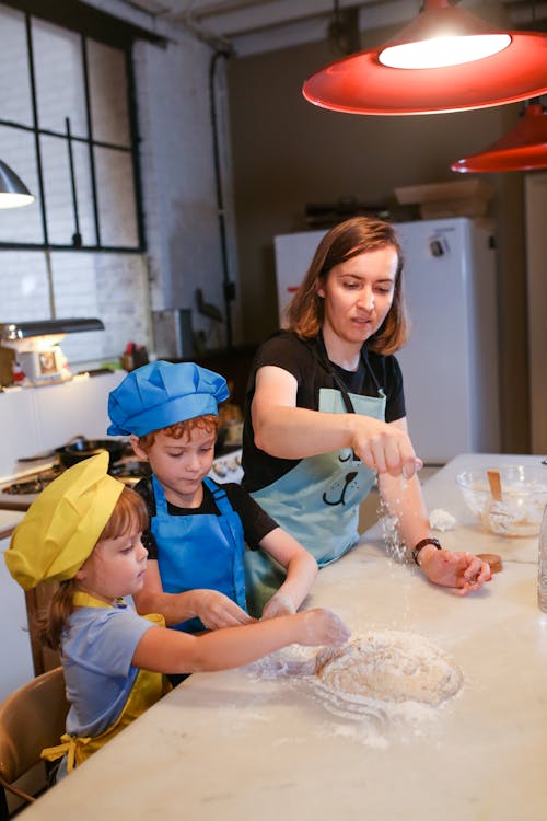 A Mom Baking with her Children in a Kitchen