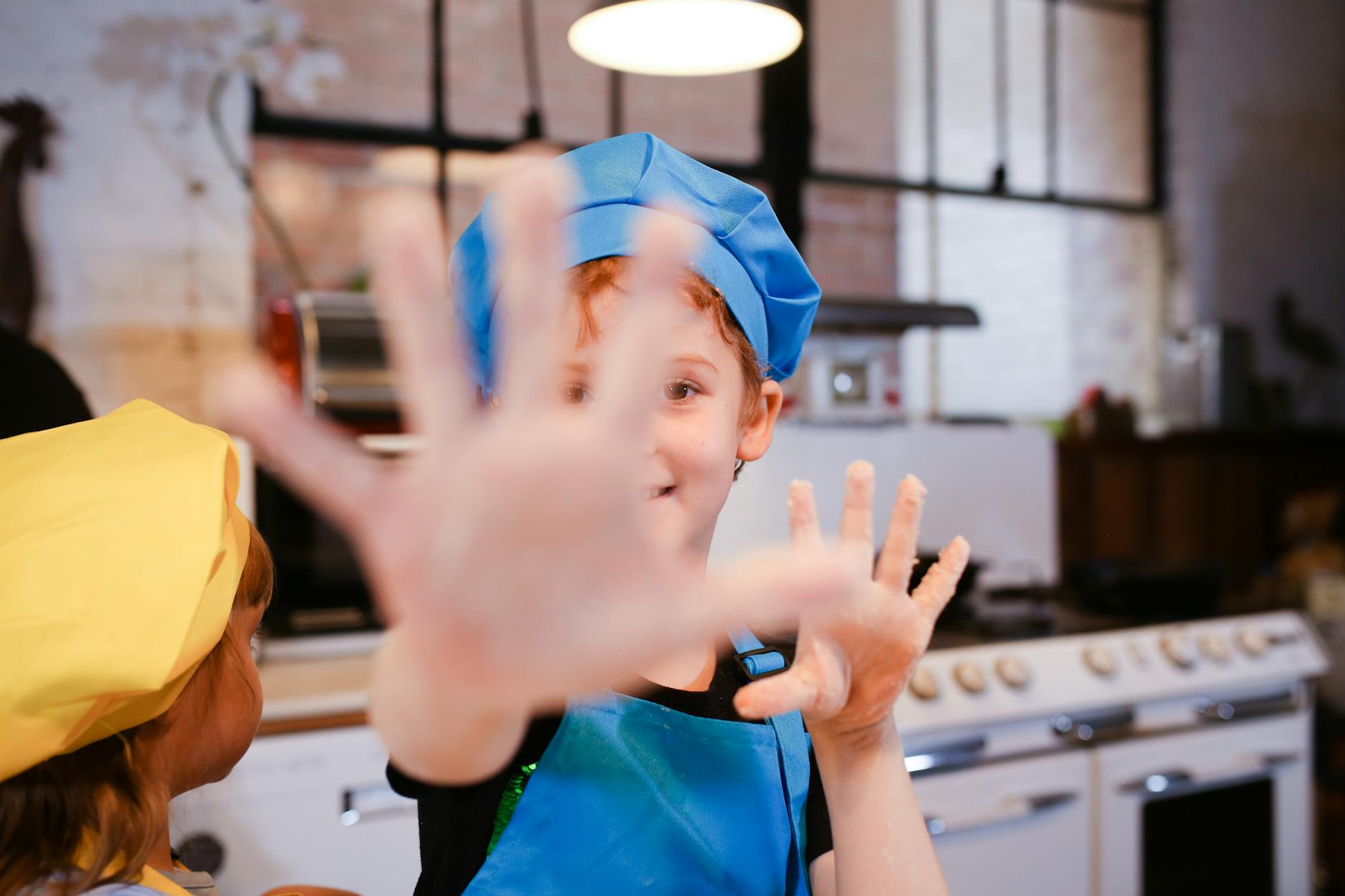 The Importance of Kitchen Safety: Tips for Cooking Kids https://www.pexels.com/photo/woman-in-blue-crew-neck-shirt-wearing-blue-cap-5593623/