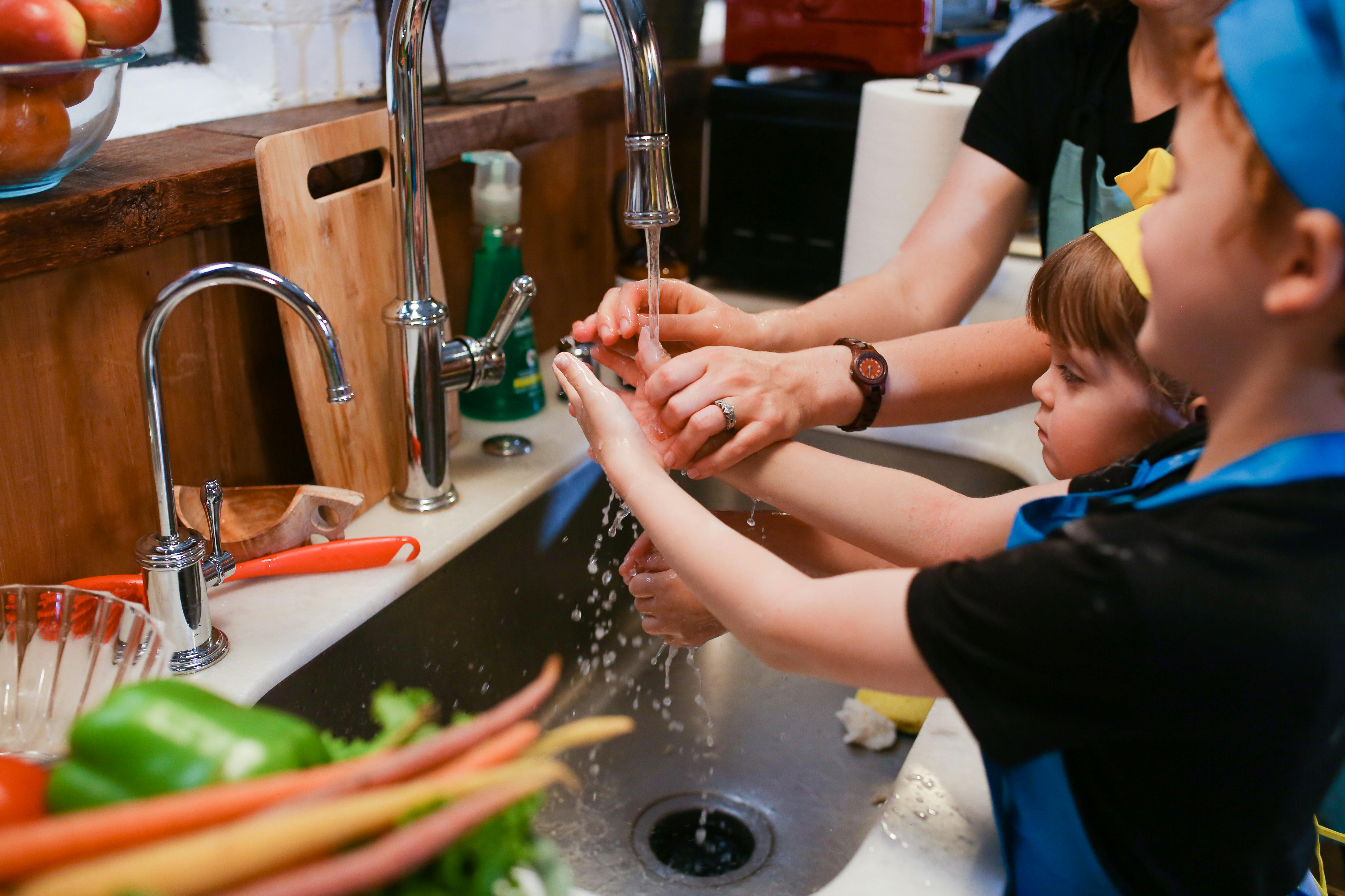 woman in black shirt washing her hands