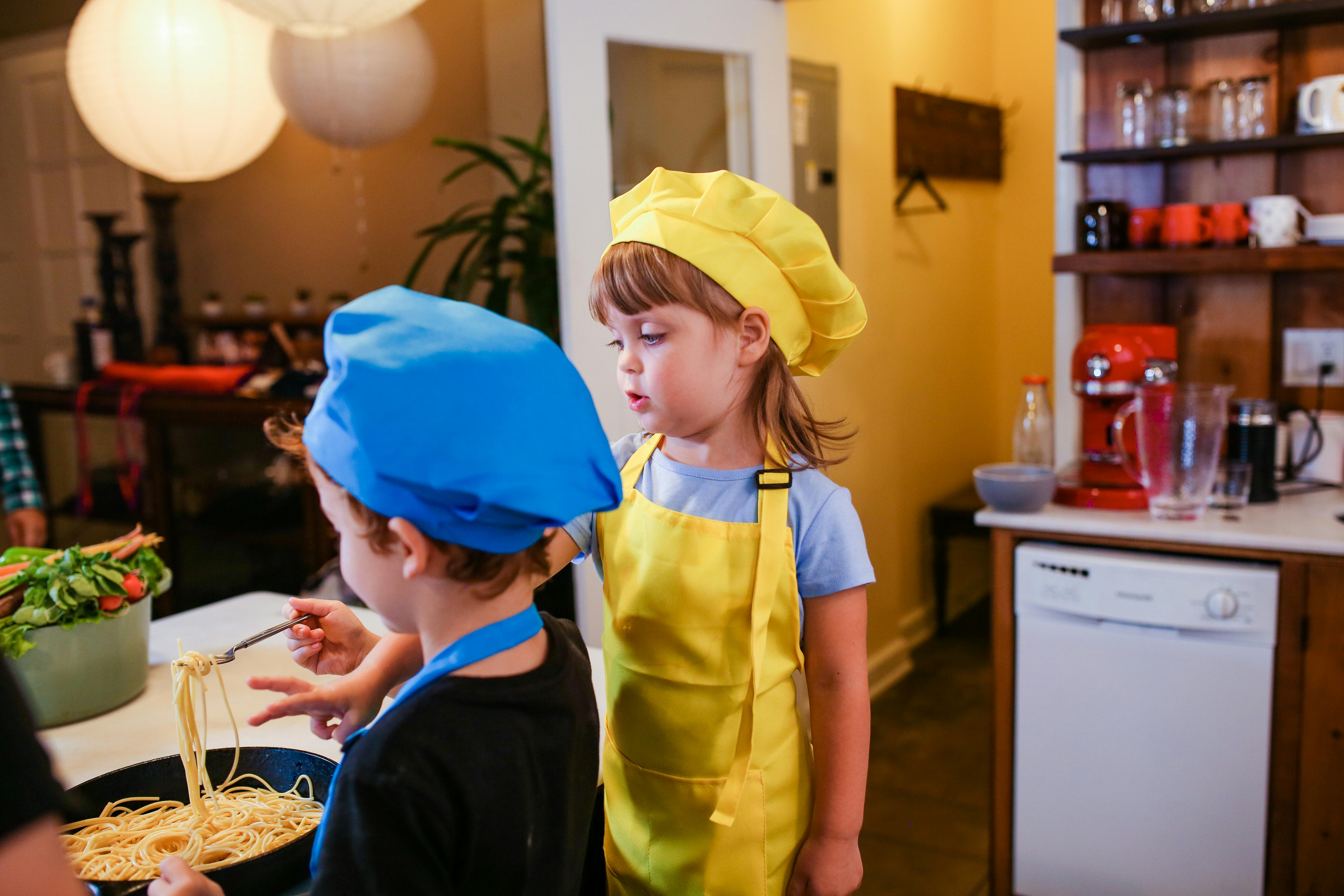 girl in yellow and blue shirt standing