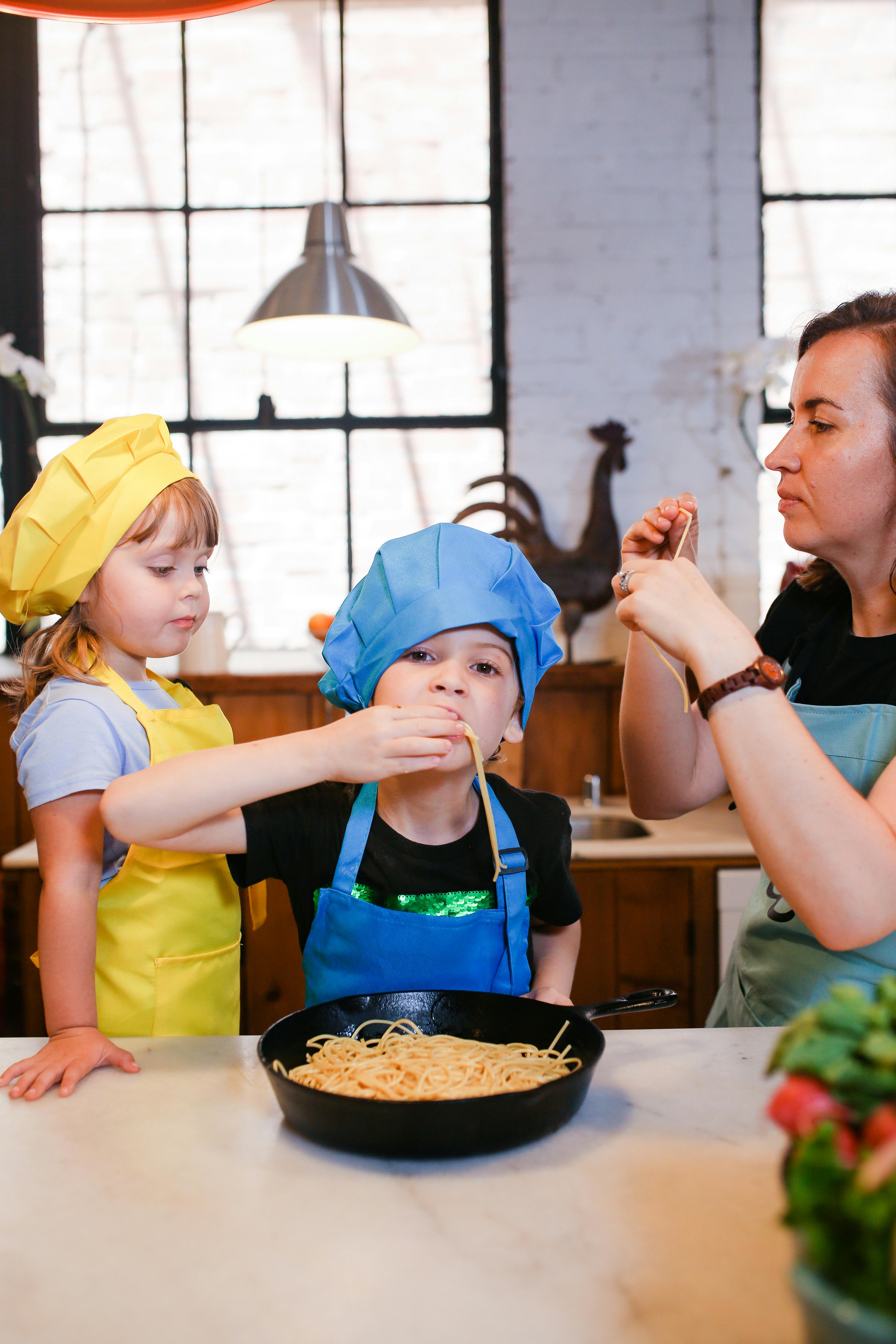 woman in yellow shirt holding girl in yellow shirt