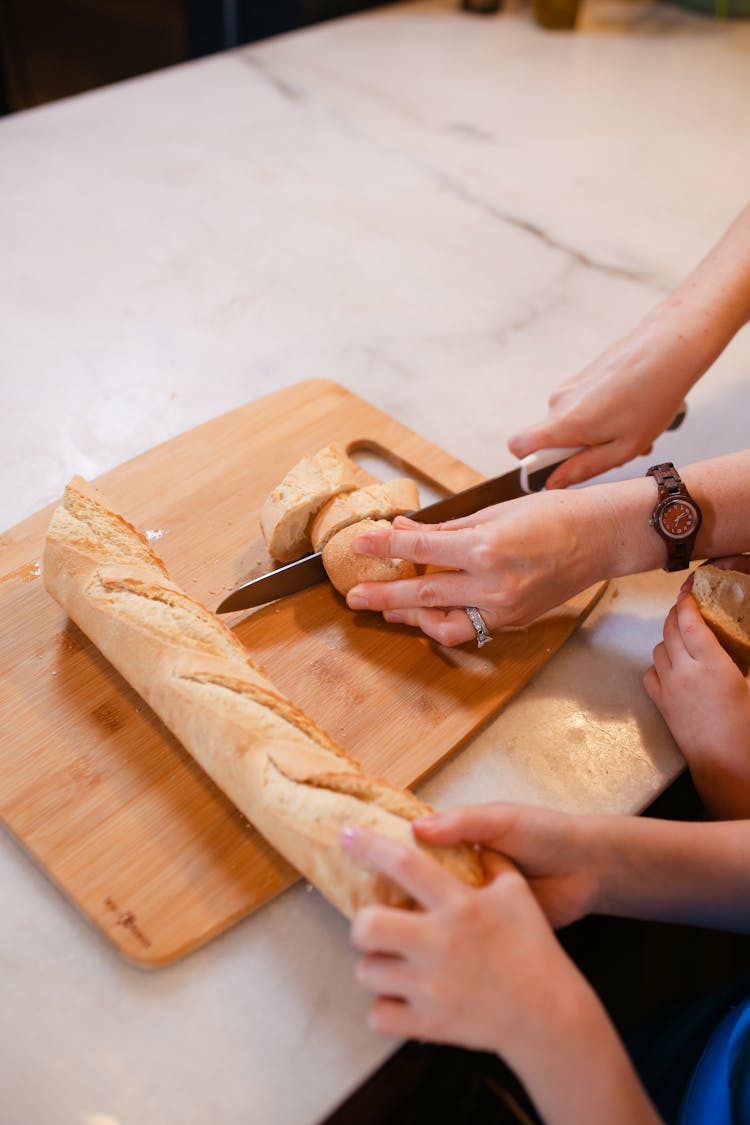 Photo Of Person Slicing A Bread