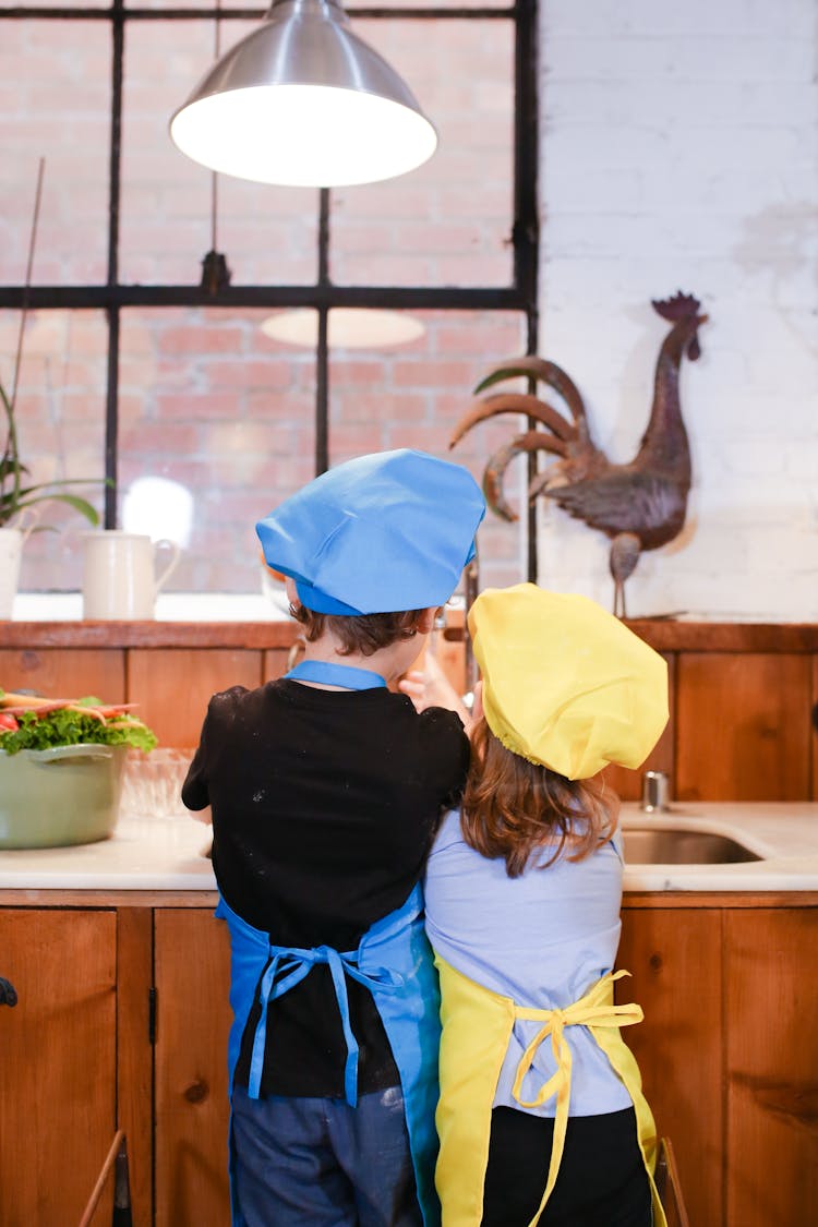 Back View Of A Boy And Girl In The Kitchen