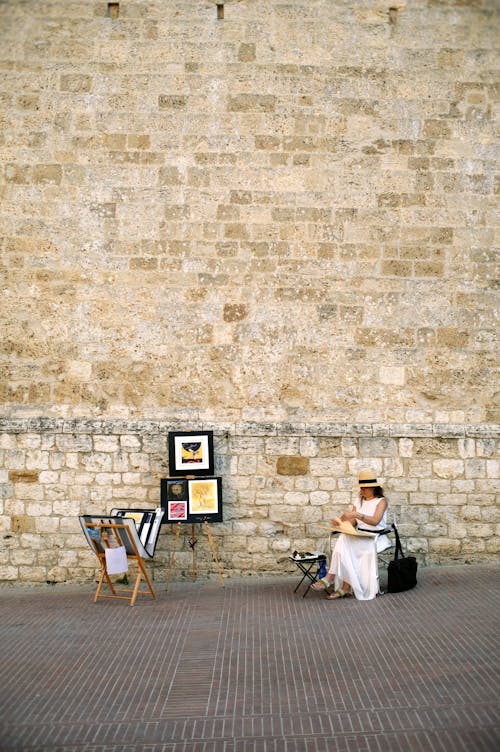 Woman Selling Paintings on a Street 