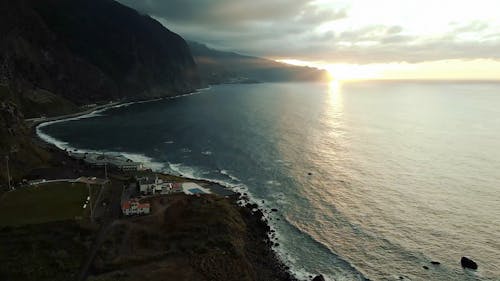 Sunrise over Sea Shore and Village