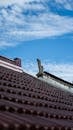 Close up of a Roof and Clouds in Blue Sky