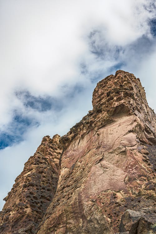 Rough rocky cliff with cracks and holes