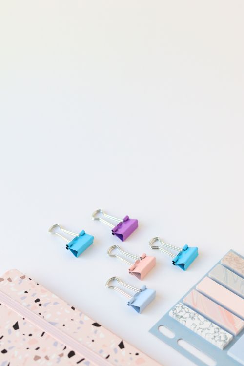 Free Aesthetic display of colorful stationery items on a minimalist desk setup. Stock Photo