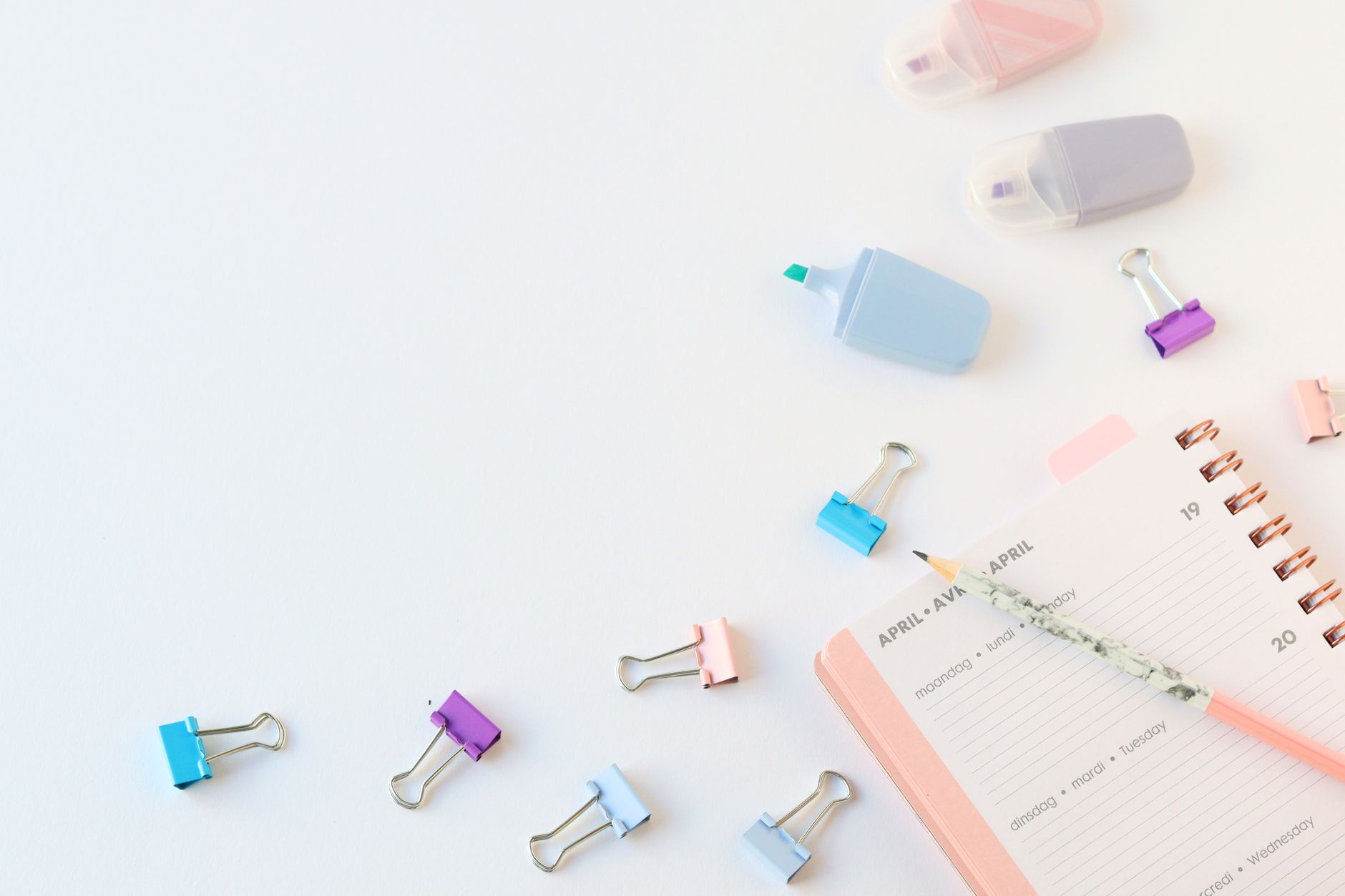 Colorful office supplies including markers and paperclips, perfect for planning and organization.