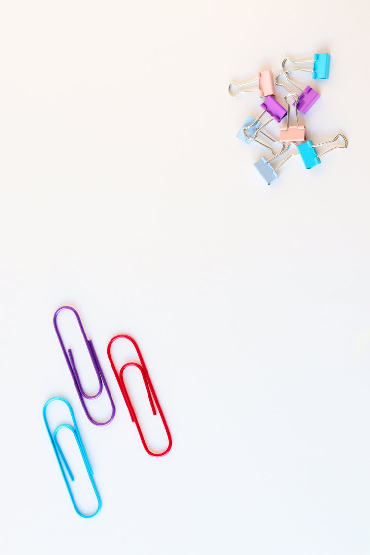 Assorted Colorful Metal Clips On Light Background