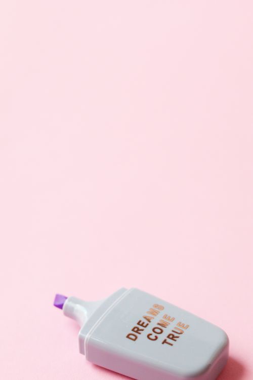 Free Close-up of a highlighter on a pink background with 'Dreams Come True' text. Stock Photo