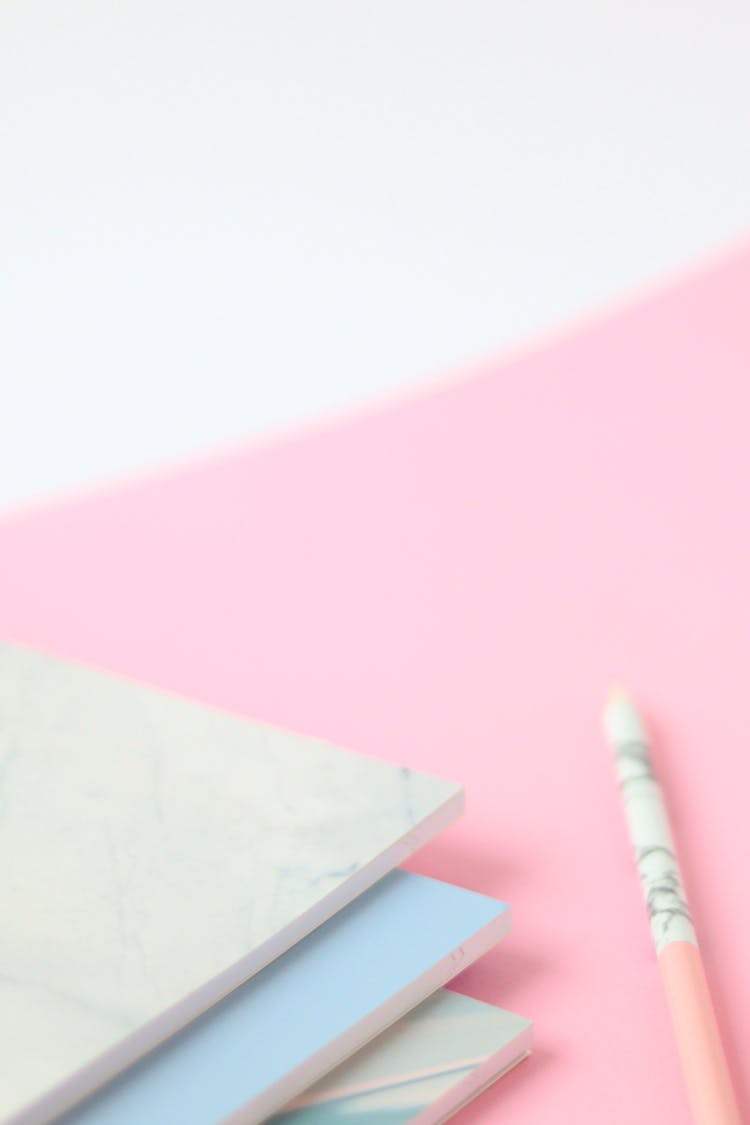 Notebooks And Pencil On The Pink Surface 