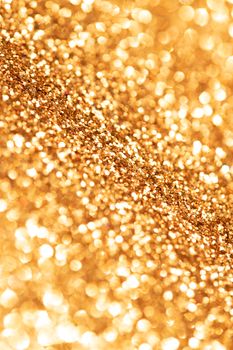Shimmering golden bokeh background with sparkling glitter effect.