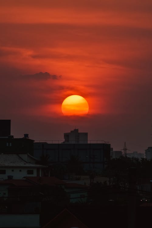 City building against orange sunset sky