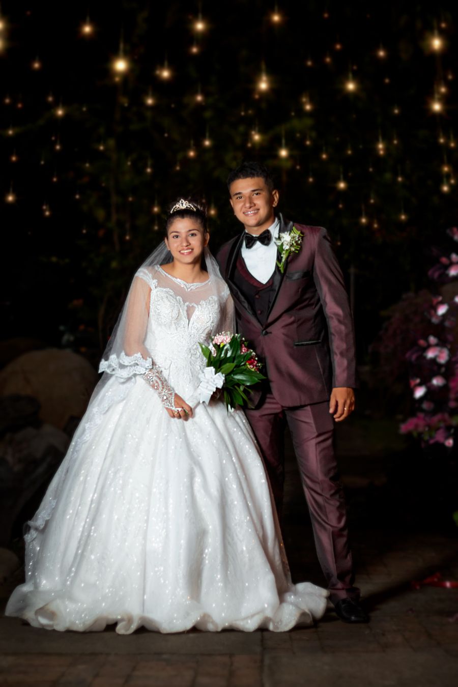 Wedding photography — bride and groom celebrating under lights