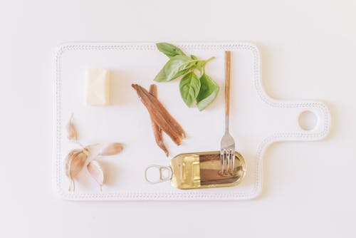 Canned Anchovies with Garlic, Butter and Herbs on a Cutting Board 