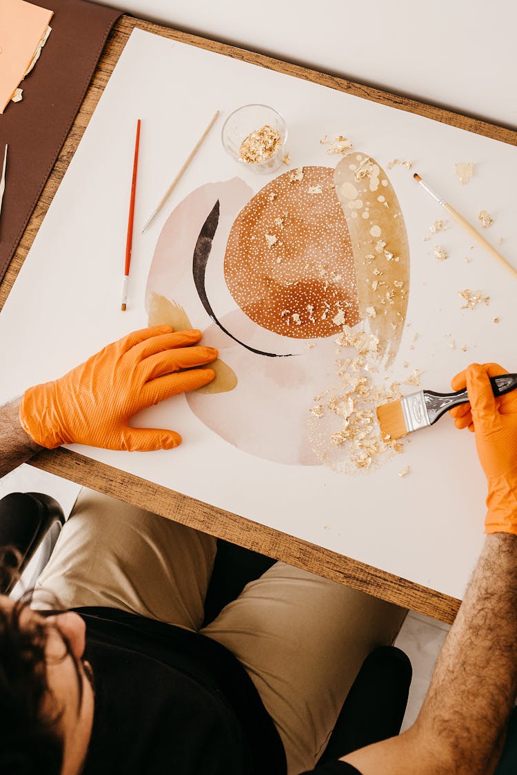 Artist In Rubber Gloves Creating Abstract Artwork