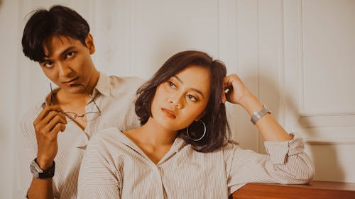 Man and Woman in White and Brown Stripe Dress Shirt