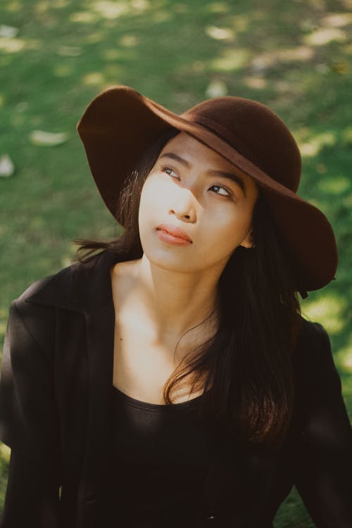 Woman in Black Shirt Wearing Brown Hat