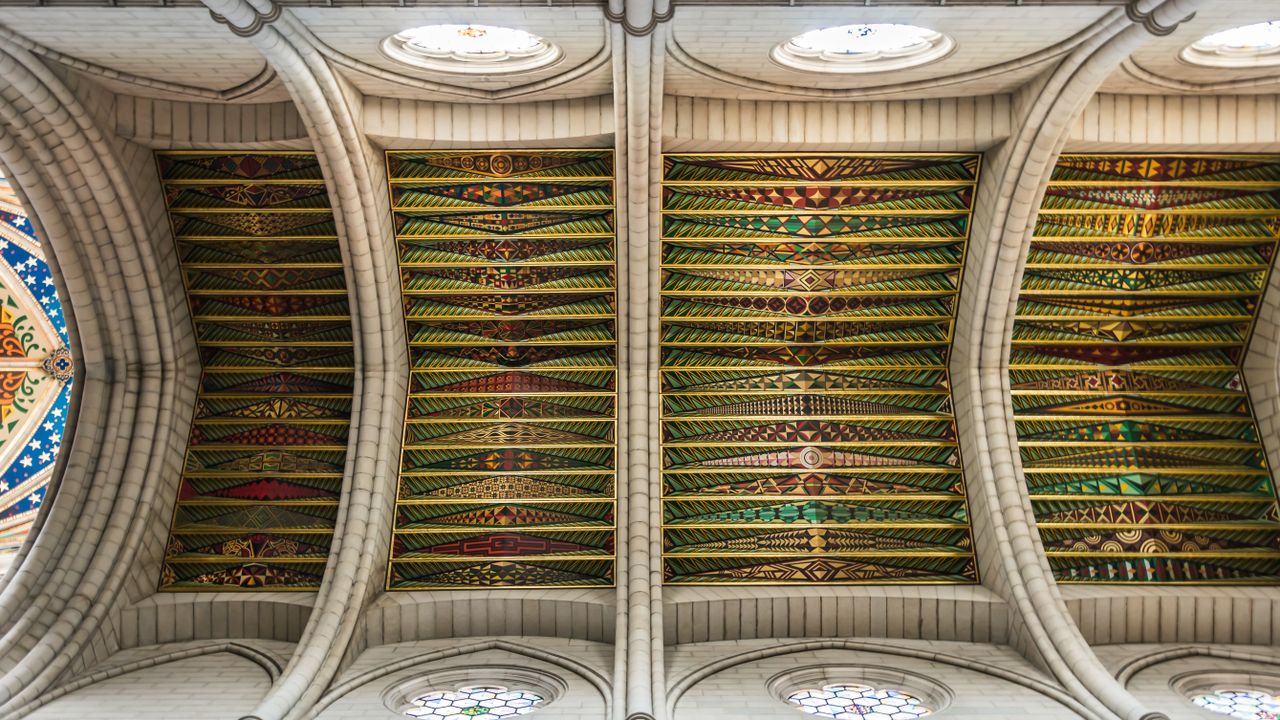 intricately designed cathedral ceiling with vibrant patterns and arche