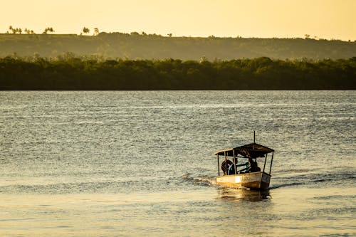 A Boat on Sea During Sunset