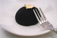 Stainless Steel Fork on Black Cake