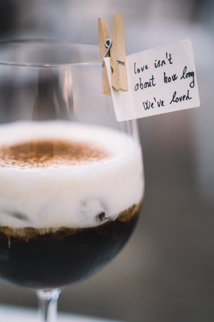 A Coffee In A Glass With A Letter Note In A Paper