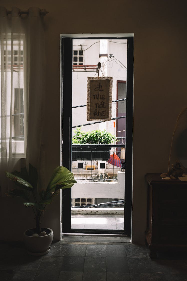 Brown Woven Cloth Hanging On Wooden Framed Glass Door 