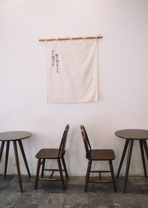 Wooden Table and Chairs and a Fabric Sign