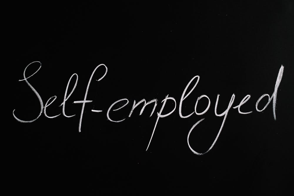 Self employed written on black borad