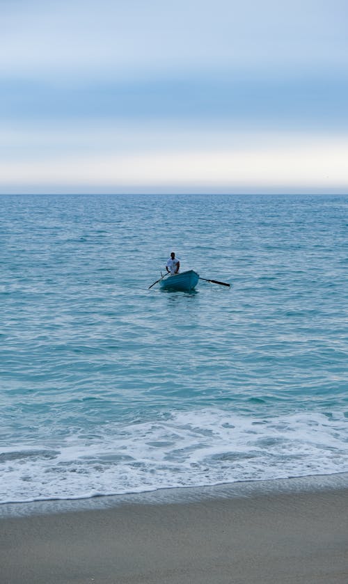 Man Rowing a Boat Into the Shore