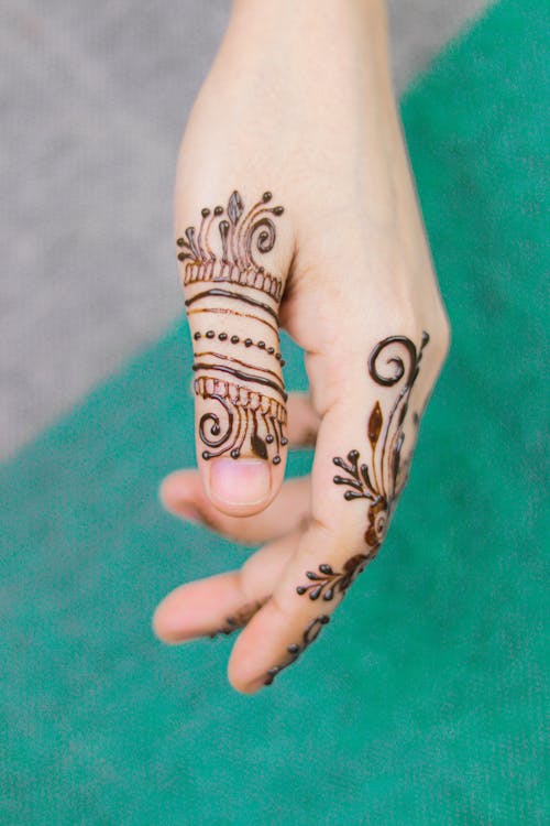 Person With Black Henna Tattoo On Hand