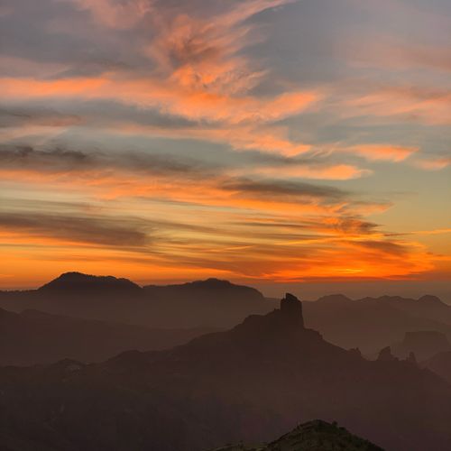 Free Stunning sunset view over Cruz de Tejeda, showcasing a vibrant sky and silhouette of mountain ranges. Stock Photo