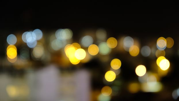 Soft focus bokeh lights in various colors create a dreamy nightscape.